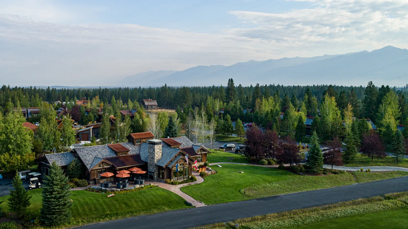 The Wilderness Club clubhouse from the air, with the Purcell mountains behind